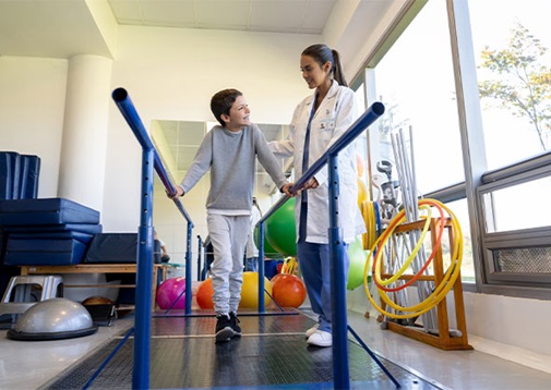 A young boy doing rehab with his therapist